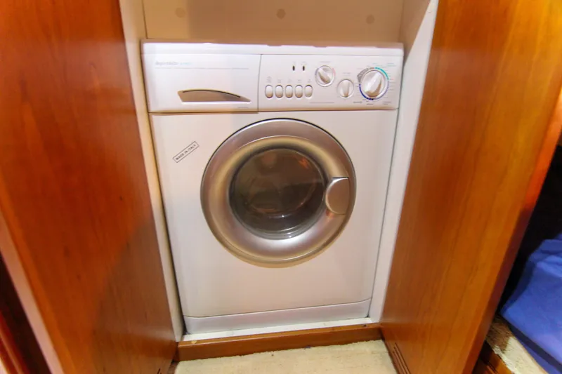 Slide: The Image of Washing machine inside 2006 Riviera 47 Open Flybridge Series II yacht's wooden cabinet. - 31