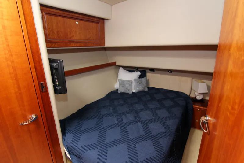 Slide: The Image of Cozy bedroom in 2006 Riviera 47 Open Flybridge Series II yacht with elegant wood finishes. - 33