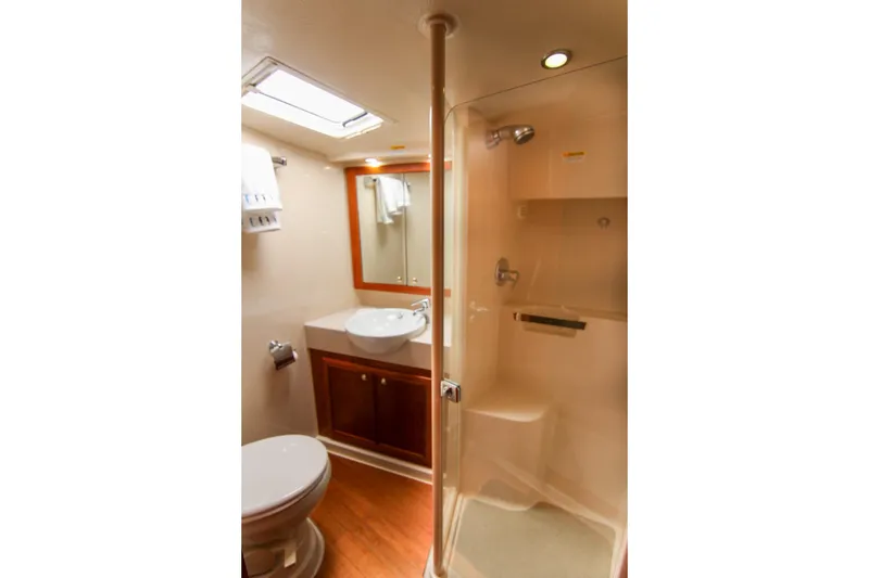 Slide: The Image of Luxurious bathroom in 2006 Riviera 47 Open Flybridge Series II yacht, featuring shower and vanity. - 34