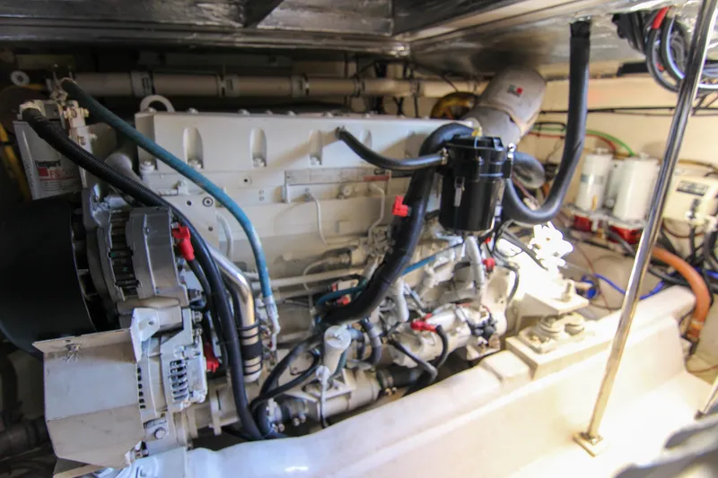 Slide: The Image of Engine room of a 2006 Riviera 47 Open Flybridge Series II yacht, showcasing detailed machinery. - 38