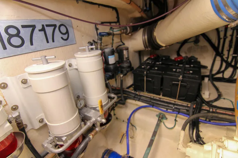 Slide: The Image of Engine room of 2006 Riviera 47 Open Flybridge Series II with filters and batteries. - 40