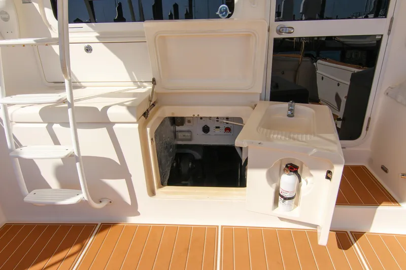 Slide: The Image of 2006 Riviera 47 Open Flybridge Series II yacht cockpit with storage and fire extinguisher. - 44