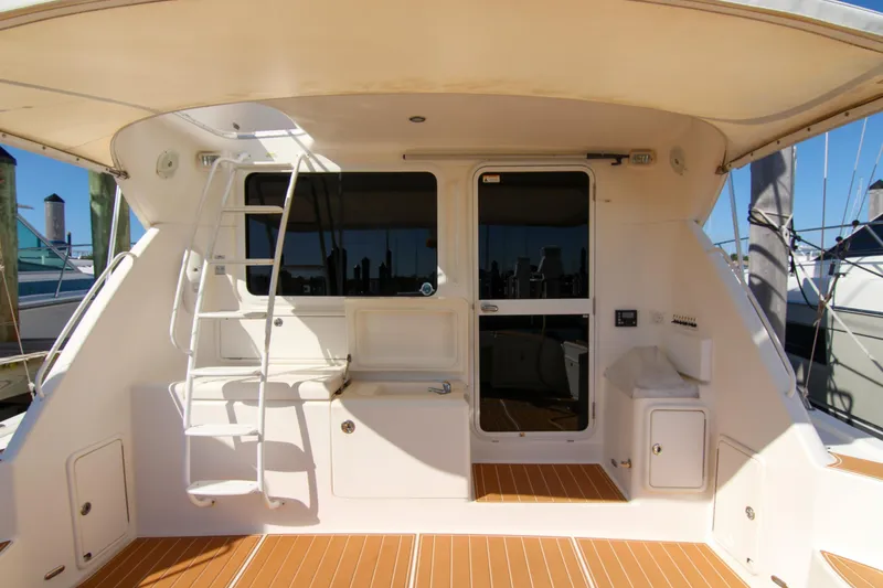 Slide: The Image of 2006 Riviera 47 Open Flybridge Series II yacht with spacious deck and ladder access. - 46