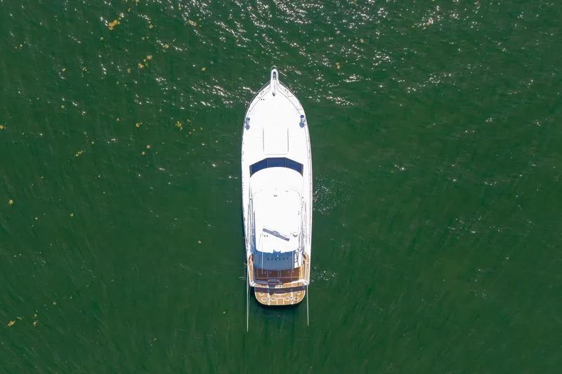 Slide: The Image of Aerial view of 2006 Riviera 47 Open Flybridge Series II yacht on green water. - 48