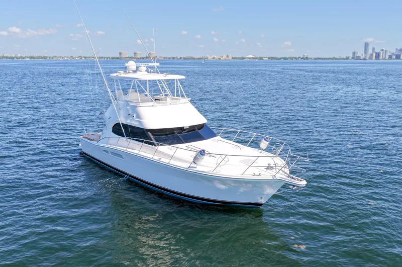 Slide: The Image of 2006 Riviera 47 Open Flybridge Series II yacht cruising on calm blue waters. - 49