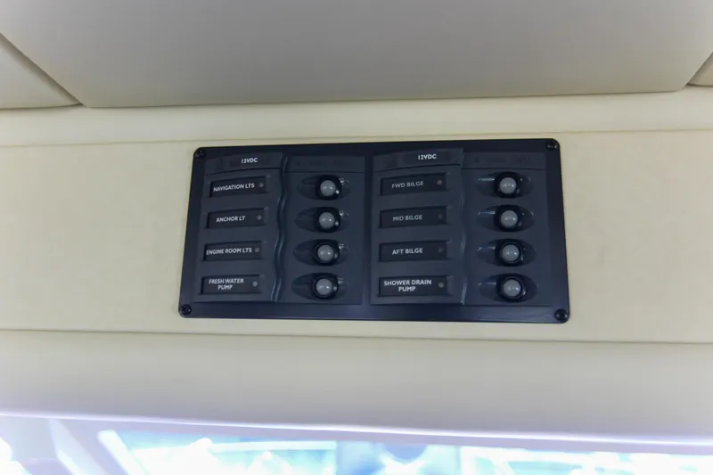 Slide: The Image of Control panel on 2006 Riviera 47 Open Flybridge Series II yacht, featuring various switches. - 5