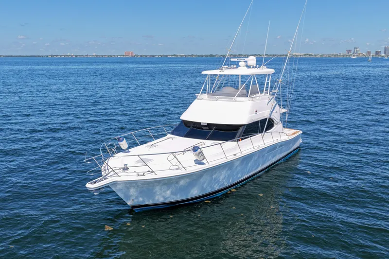 Slide: The Image of 2006 Riviera 47 Open Flybridge Series II yacht on calm blue waters. - 52