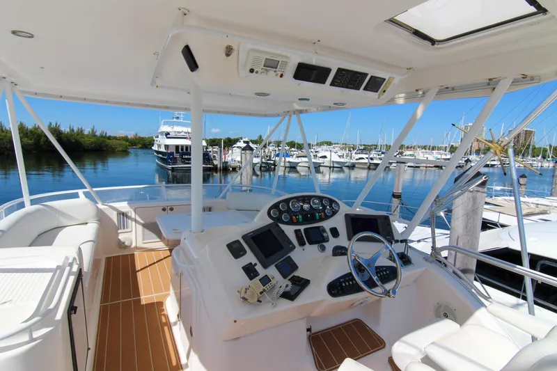Slide: The Image of 2006 Riviera 47 Open Flybridge Series II yacht interior with helm, docked at marina. - 6