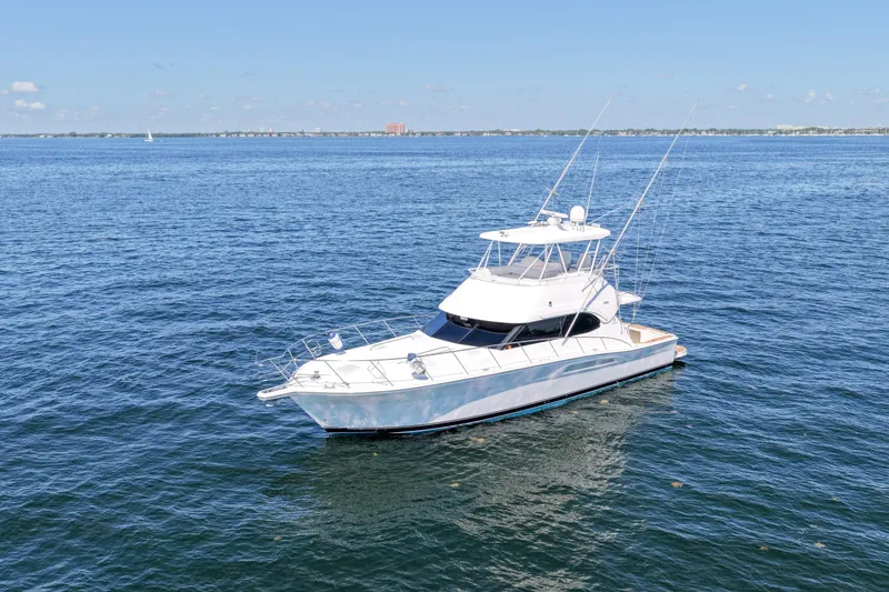 Slide: The Image of 2006 Riviera 47 Open Flybridge Series II yacht on calm blue waters. - 62