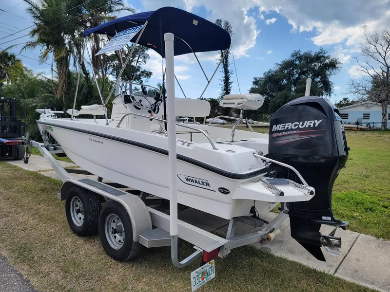 Slide: The Image of 2013 Boston Whaler 170 Dauntless boat with Mercury engine on trailer. - 3