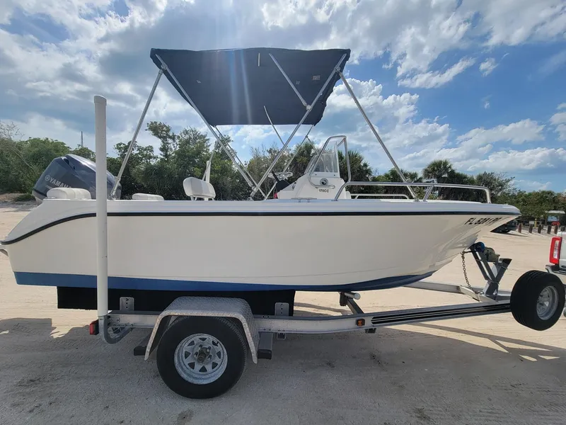 Slide: The Image of 2013 Edgewater 170CC boat on trailer under blue sky. - 9