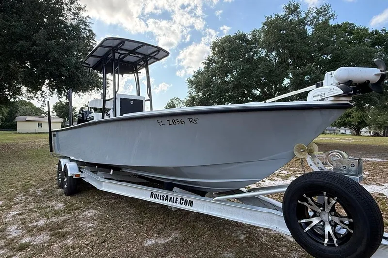 The Image of 2017 Dorado 25 SE boat on trailer, parked outdoors under a cloudy sky. - 1
