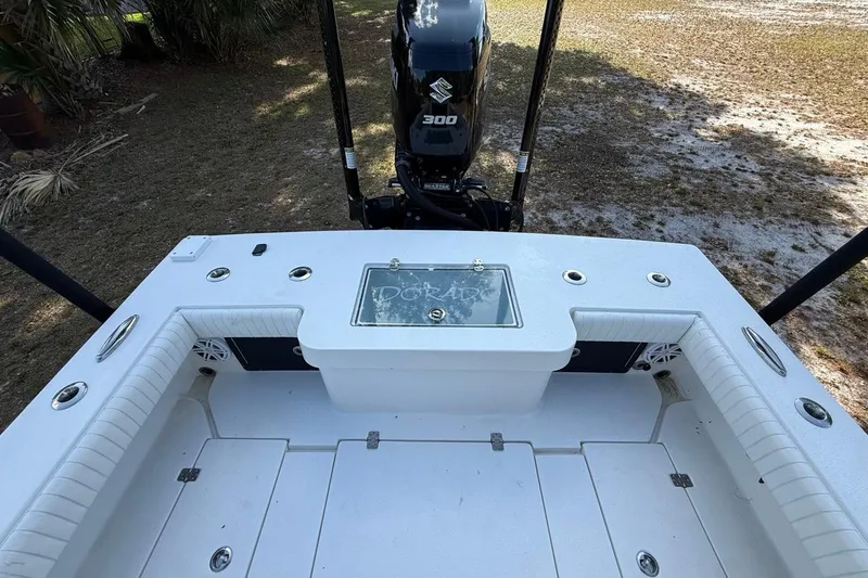 Slide: The Image of 2017 Dorado 25 SE boat deck with Suzuki 300 engine, outdoor setting. - 10