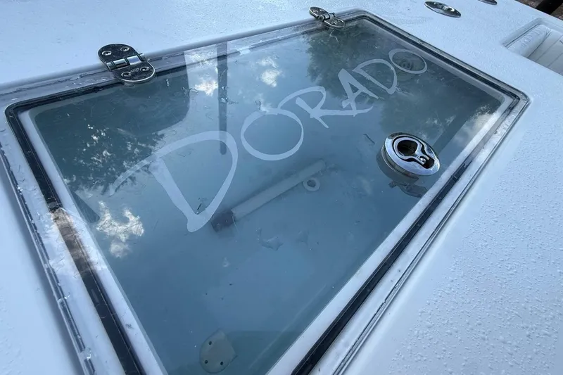 Slide: The Image of Close-up of a 2017 Dorado 25 SE boat hatch with visible logo. - 11