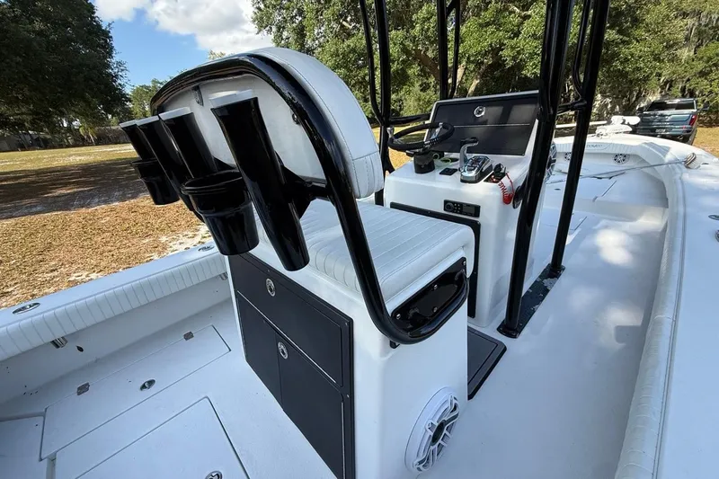 Slide: The Image of 2017 Dorado 25 SE boat interior with helm, seating, and rod holders. - 15