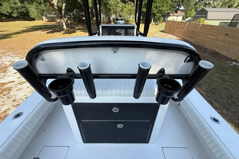 Slide: The Image of 2017 Dorado 25 SE boat interior with rod holders and storage compartments. - 16