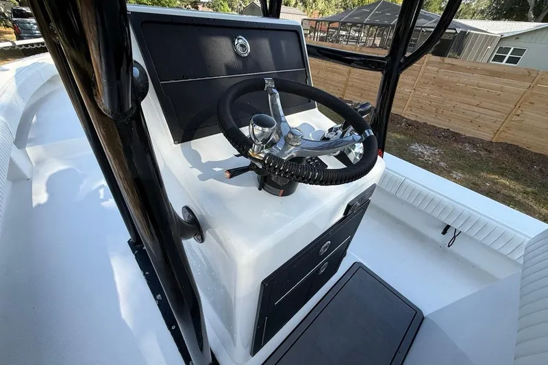 Slide: The Image of 2017 Dorado 25 SE boat console with steering wheel and controls. - 17