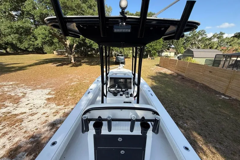 Slide: The Image of 2017 Dorado 25 SE boat with center console, parked on grassy area. - 18