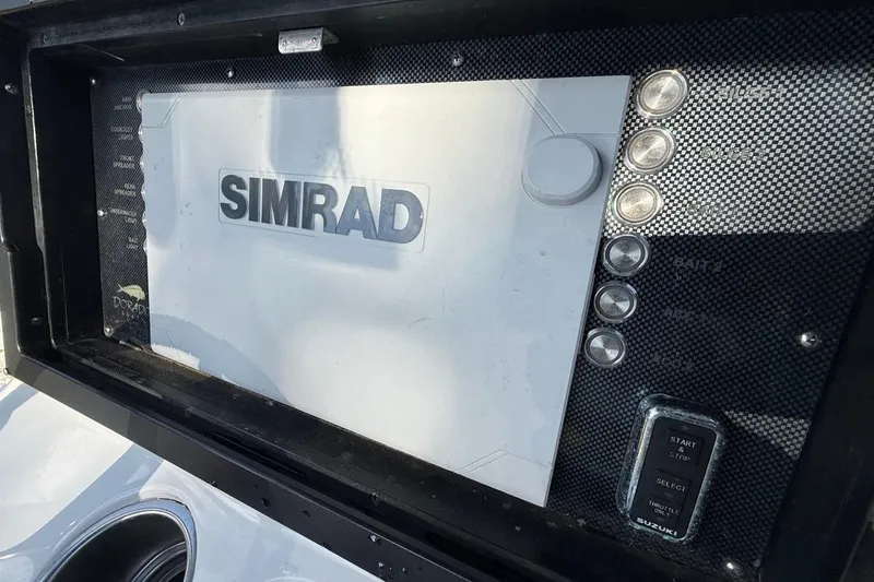 Slide: The Image of Simrad display on 2017 Dorado 25 SE boat dashboard with control buttons. - 19