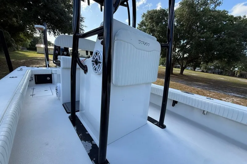 Slide: The Image of 2017 Dorado 25 SE boat interior with white seating and black frame. - 20