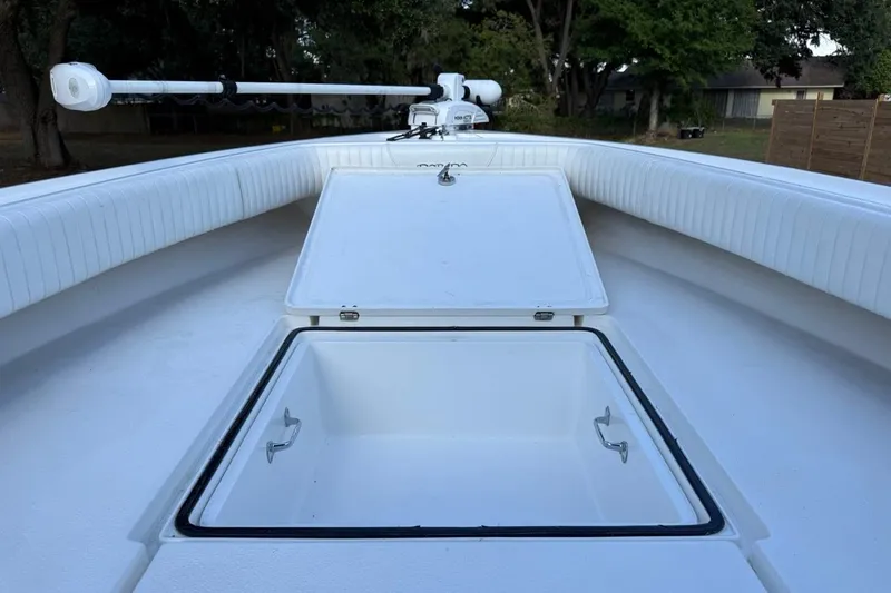 Slide: The Image of 2017 Dorado 25 SE boat with open storage compartment, white interior, and trolling motor. - 23