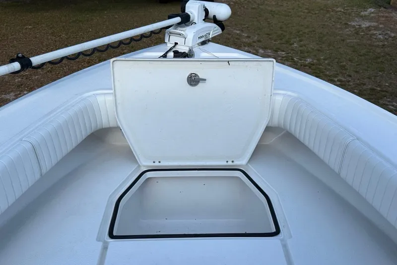 Slide: The Image of 2017 Dorado 25 SE boat with open storage compartment and trolling motor. - 24
