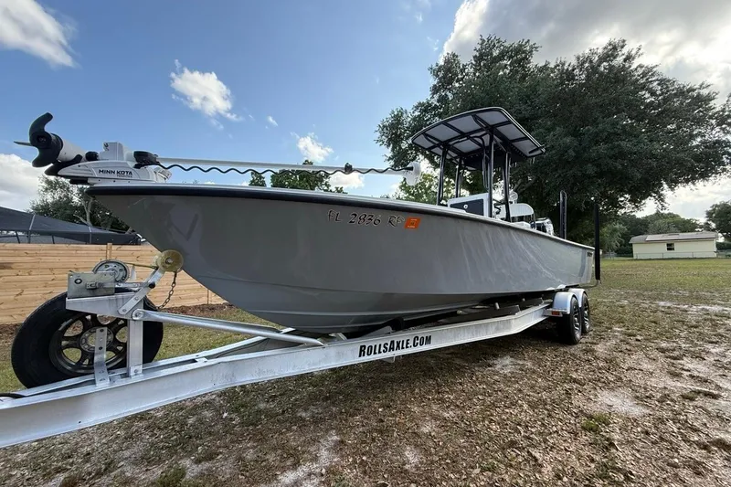 Slide: The Image of 2017 Dorado 25 SE boat on trailer, featuring Minn Kota motor, parked outdoors. - 3