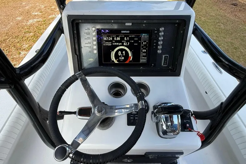 Slide: The Image of 2017 Dorado 25 SE boat dashboard with steering wheel, navigation display, and controls. - 32