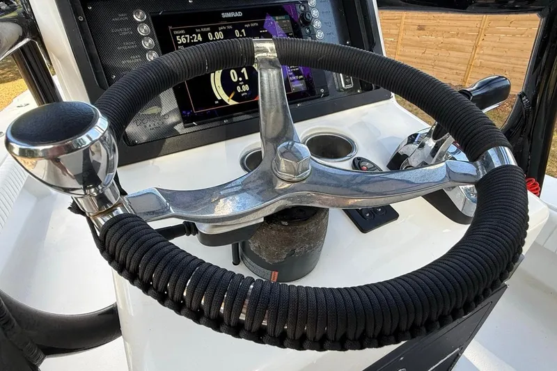 Slide: The Image of Steering wheel and controls of a 2017 Dorado 25 SE boat with Simrad display. - 33