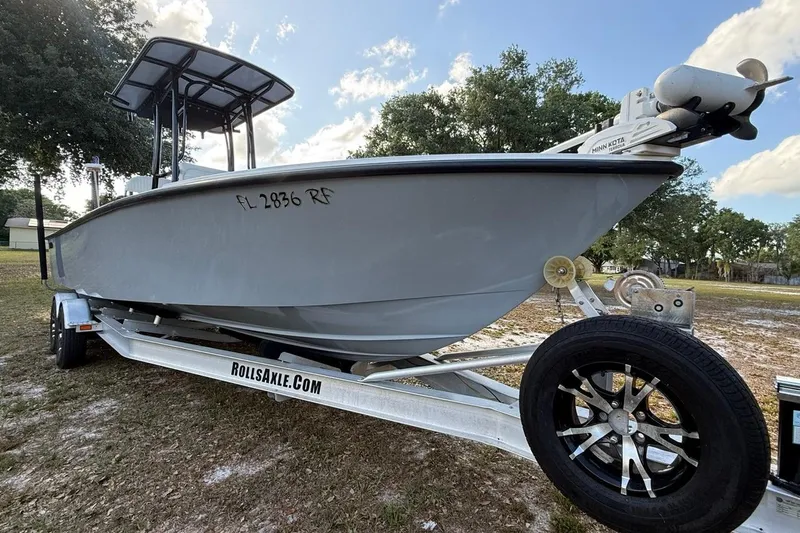 Slide: The Image of 2017 Dorado 25 SE boat on trailer, parked outdoors under a blue sky. - 34
