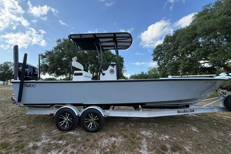 Slide: The Image of 2017 Dorado 25 SE boat on trailer, parked outdoors under a blue sky. - 5