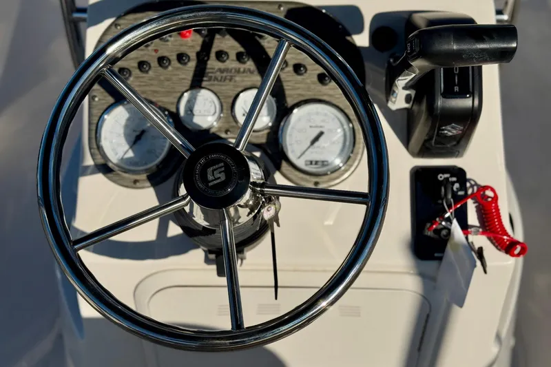 Slide: The Image of Steering console of 2025 Carolina Skiff 192 JLS boat with gauges and controls. - 10