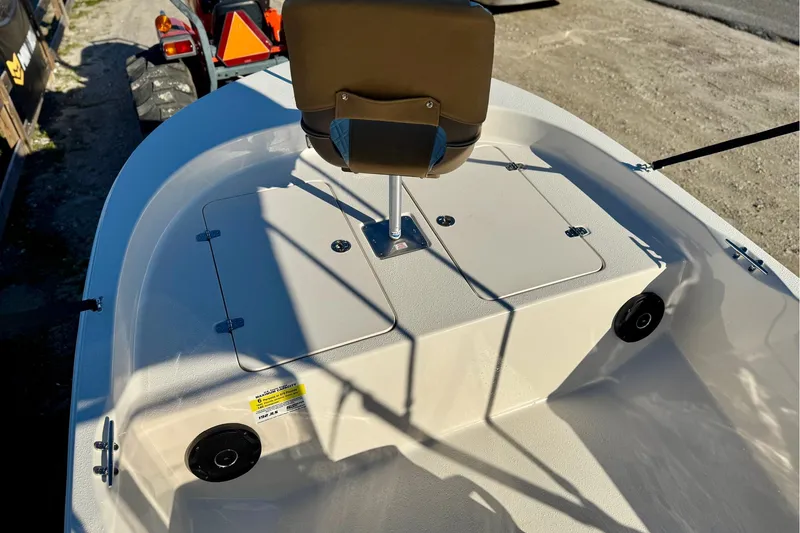 Slide: The Image of 2025 Carolina Skiff 192 JLS boat interior with seating and storage compartments. - 13
