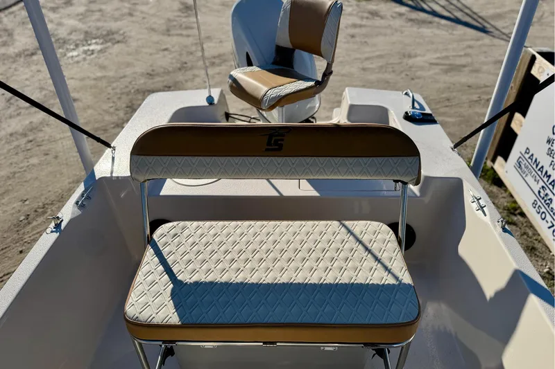 Slide: The Image of 2025 Carolina Skiff 192 JLS boat interior with cushioned seating and steering console. - 14