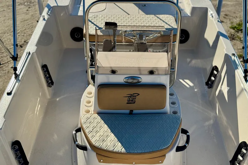 Slide: The Image of 2025 Carolina Skiff 192 JLS boat interior with steering console and seating. - 17