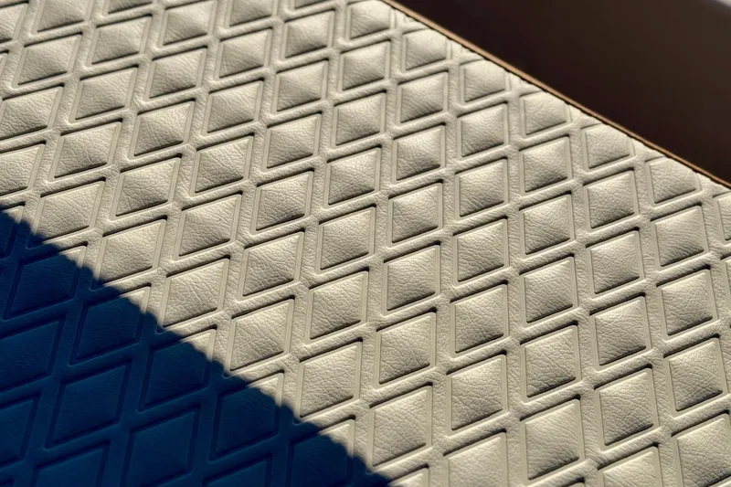 Slide: The Image of Diamond-patterned upholstery detail on 2025 Carolina Skiff 192 JLS boat. - 18