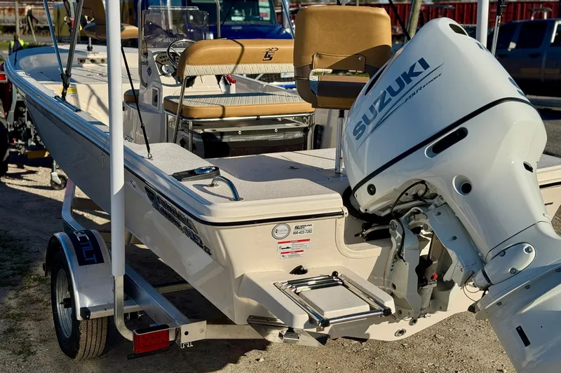 Slide: The Image of 2025 Carolina Skiff 192 JLS boat with Suzuki outboard motor on trailer. - 19
