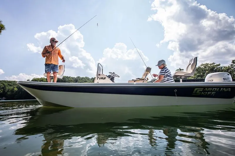 Slide: The Image of Manufacturer Provided Image: Two people fishing on a 2025 Carolina Skiff 192 JLS boat under a sunny sky. - 25