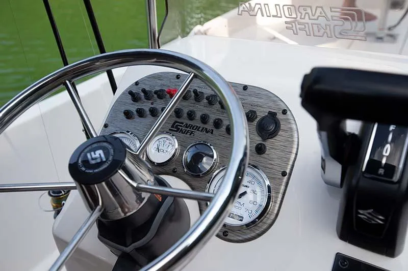 Slide: The Image of Manufacturer Provided Image: 2025 Carolina Skiff 192 JLS boat dashboard with steering wheel and control panel. - 27