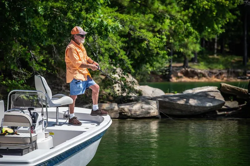 Slide: The Image of Manufacturer Provided Image: Man fishing on a 2025 Carolina Skiff 192 JLS boat in a serene lake. - 28