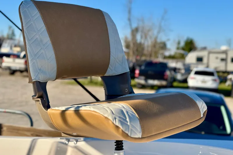 Slide: The Image of Boat seat on 2025 Carolina Skiff 192 JLS, featuring tan and white upholstery. - 6