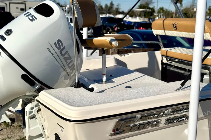 Slide: The Image of 2025 Carolina Skiff 192 JLS boat with Suzuki outboard motor, featuring tan seating. - 8