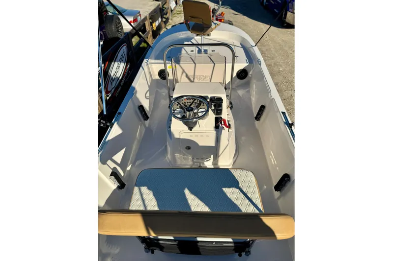 Slide: The Image of 2025 Carolina Skiff 192 JLS boat interior with steering console and seating. - 9