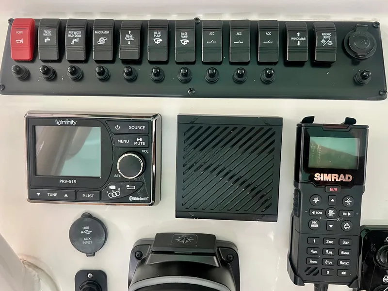 Slide: The Image of Control panel of a 2023 Sea Chaser 30HFC boat with navigation and communication equipment. - 14