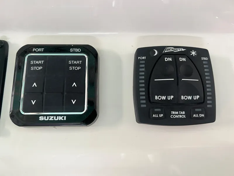 Slide: The Image of Suzuki and Bennett control panels on 2023 Sea Chaser 30HFC boat. - 15
