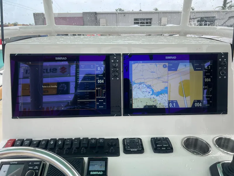 Slide: The Image of 2023 Sea Chaser 30HFC boat dashboard with dual Simrad navigation screens. - 18