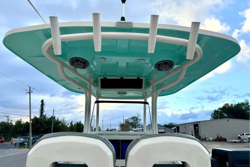 Slide: The Image of 2023 Sea Chaser 30 HFC CC boat with teal canopy and rod holders. - 24