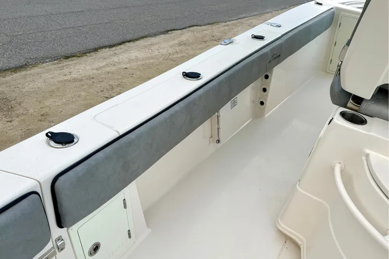 Slide: The Image of 2023 Sea Chaser 30 HFC CC boat interior, featuring sleek seating and storage compartments. - 27