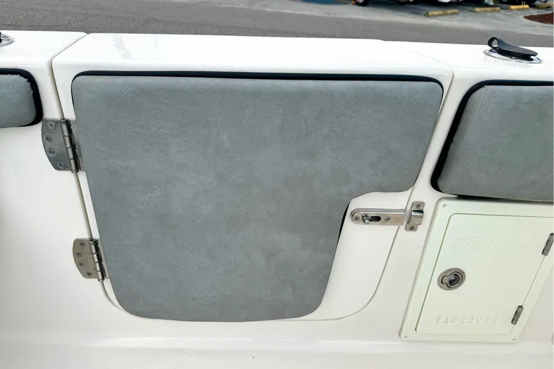Slide: The Image of 2023 Sea Chaser 30 HFC CC boat interior with gray padded door and washdown compartment. - 28