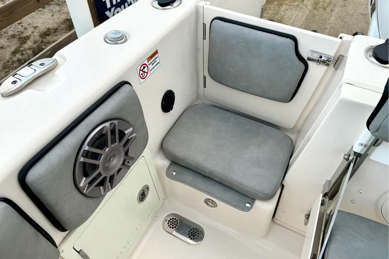 Slide: The Image of 2023 Sea Chaser 30 HFC CC boat interior with cushioned seating and speaker system. - 31